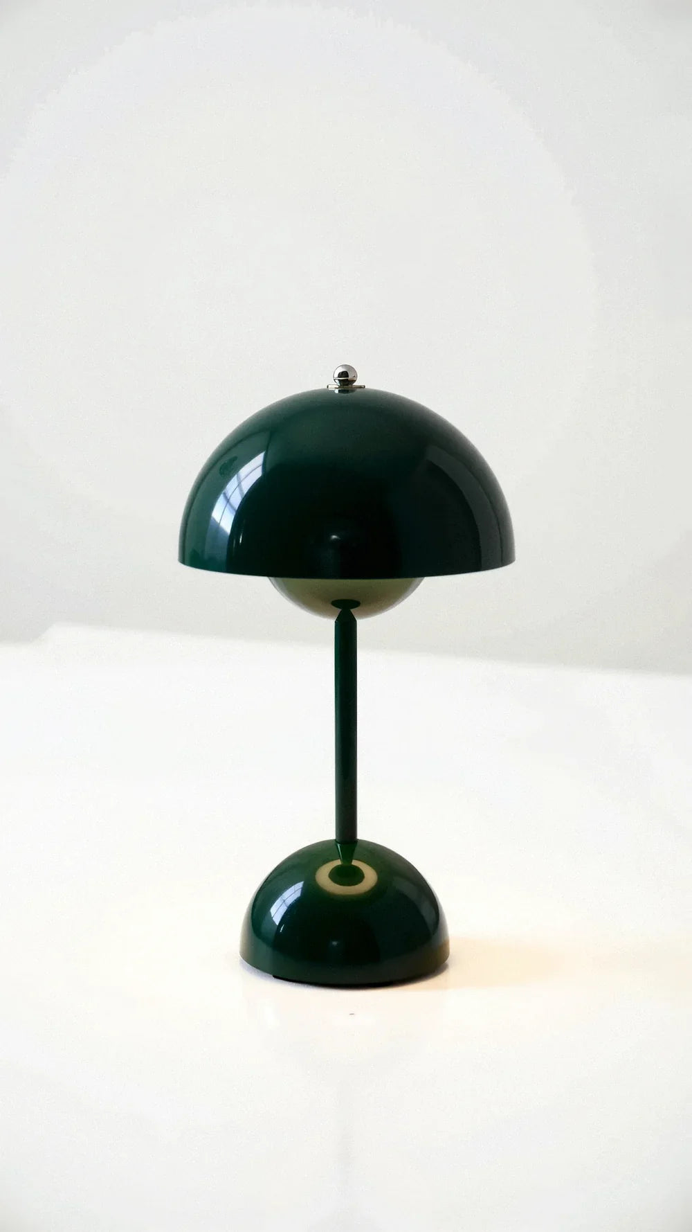 Dark green portable mushroom table lamp isolated on a plain background