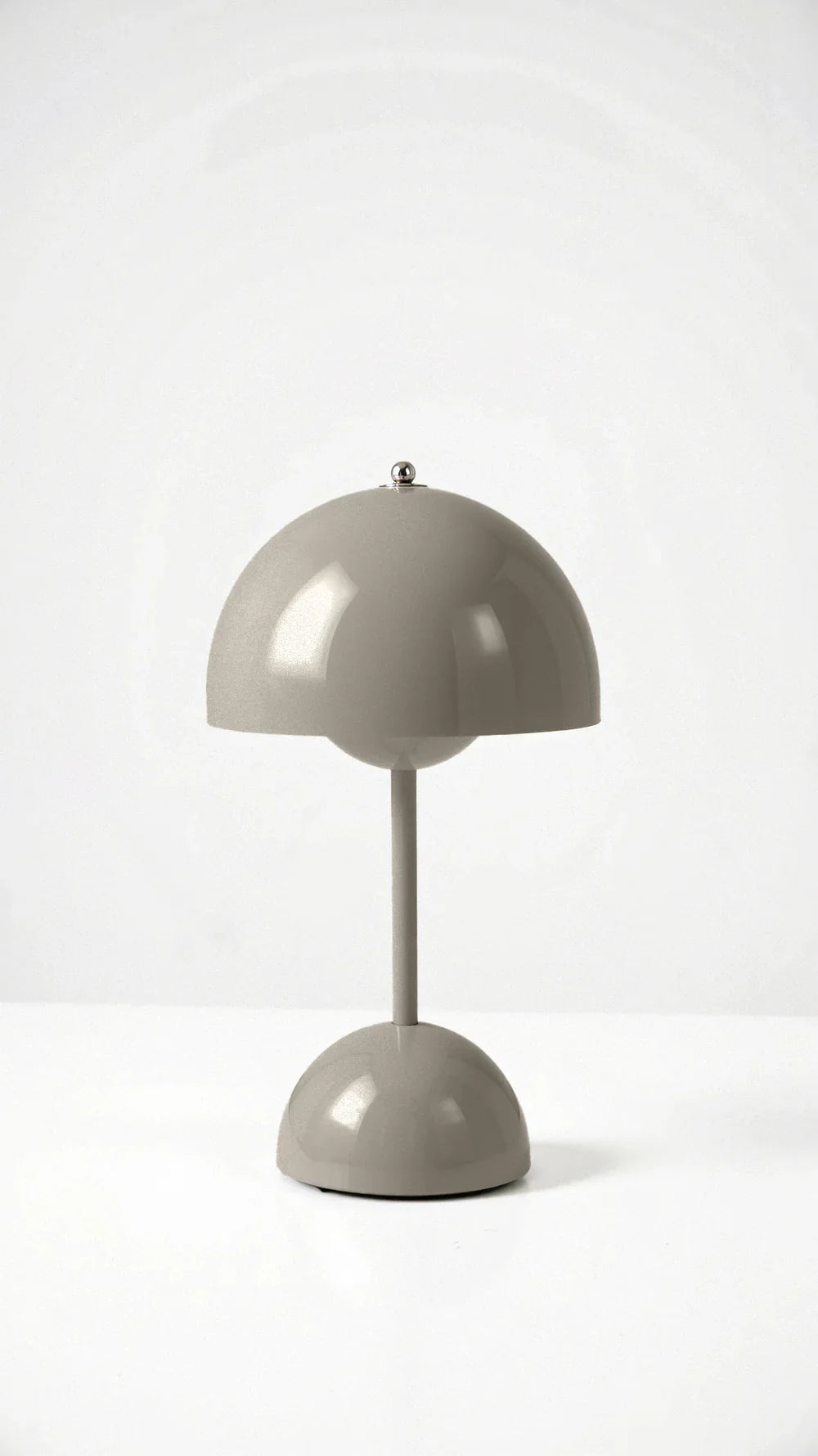 Modern grey cordless mushroom table lamp showcasing its sleek, minimalist dome silhouette