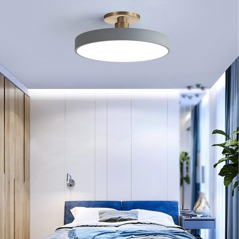 Grey round LED ceiling light perfectly complementing a modern blue bedroom interior