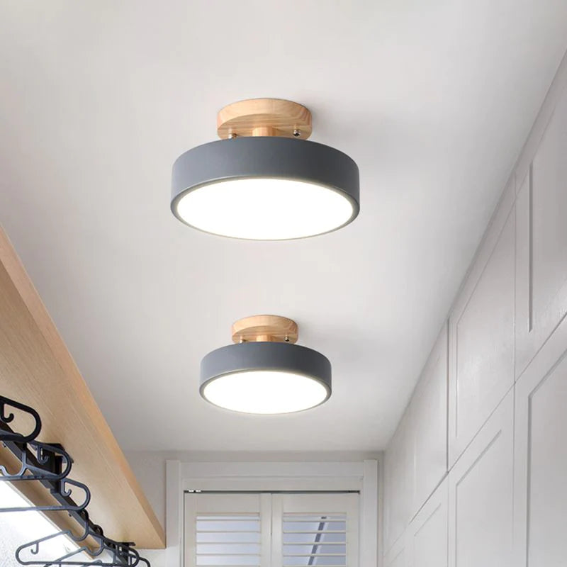 Two grey modern semi flush mount ceiling lights illuminating a clean, white walk-in wardrobe
