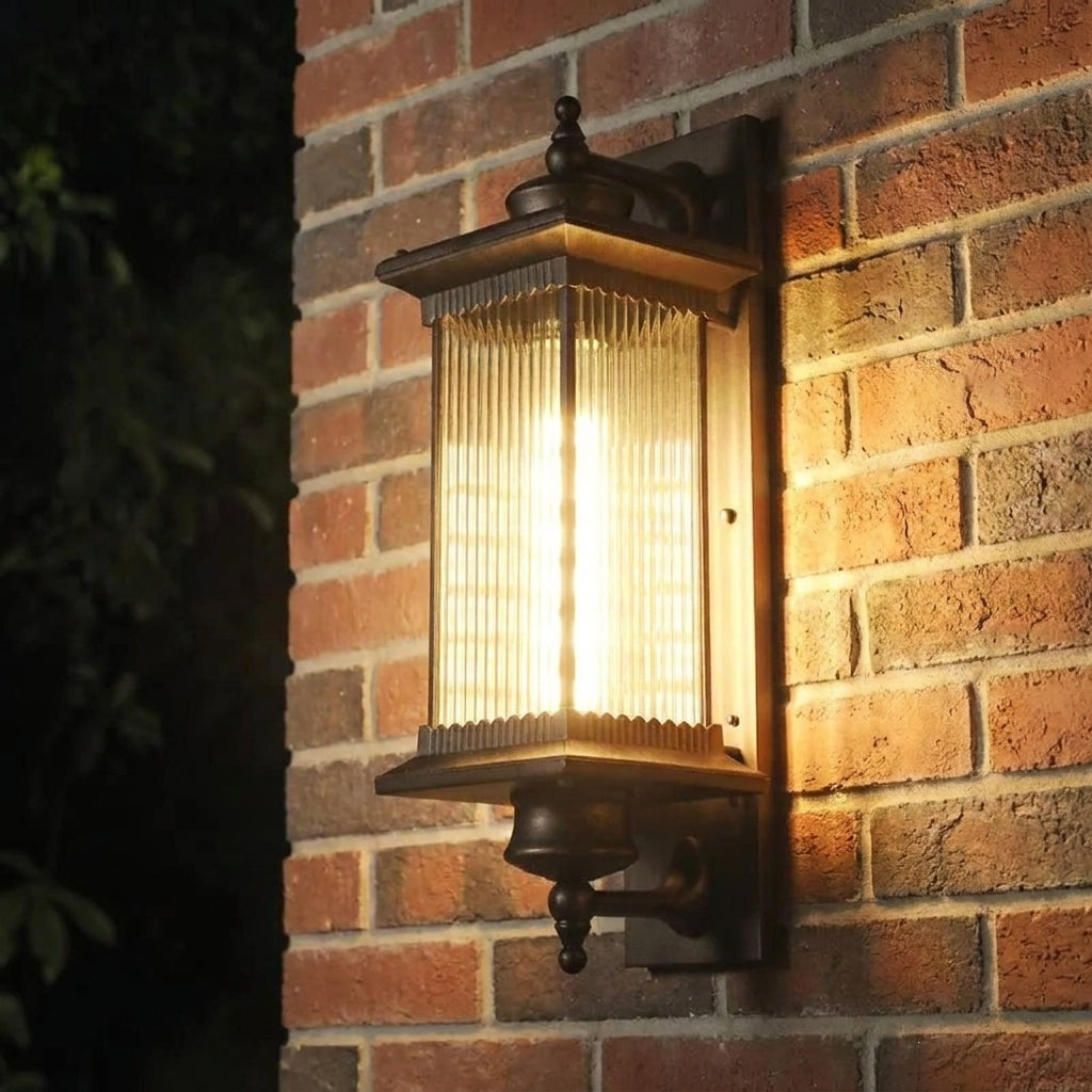 Gumzi exterior lantern wall light glowing at night