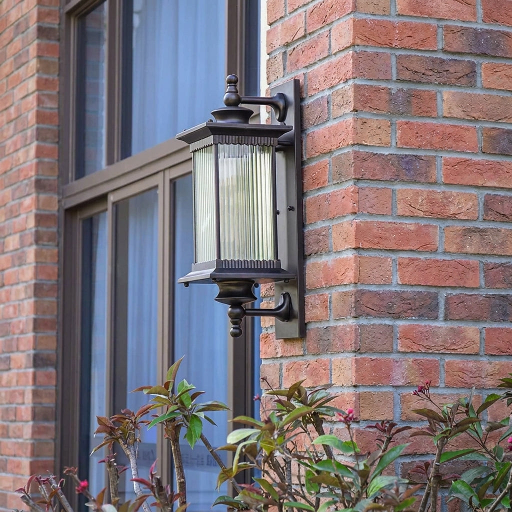 Gumzi exterior lantern wall light on a brick wall near a window