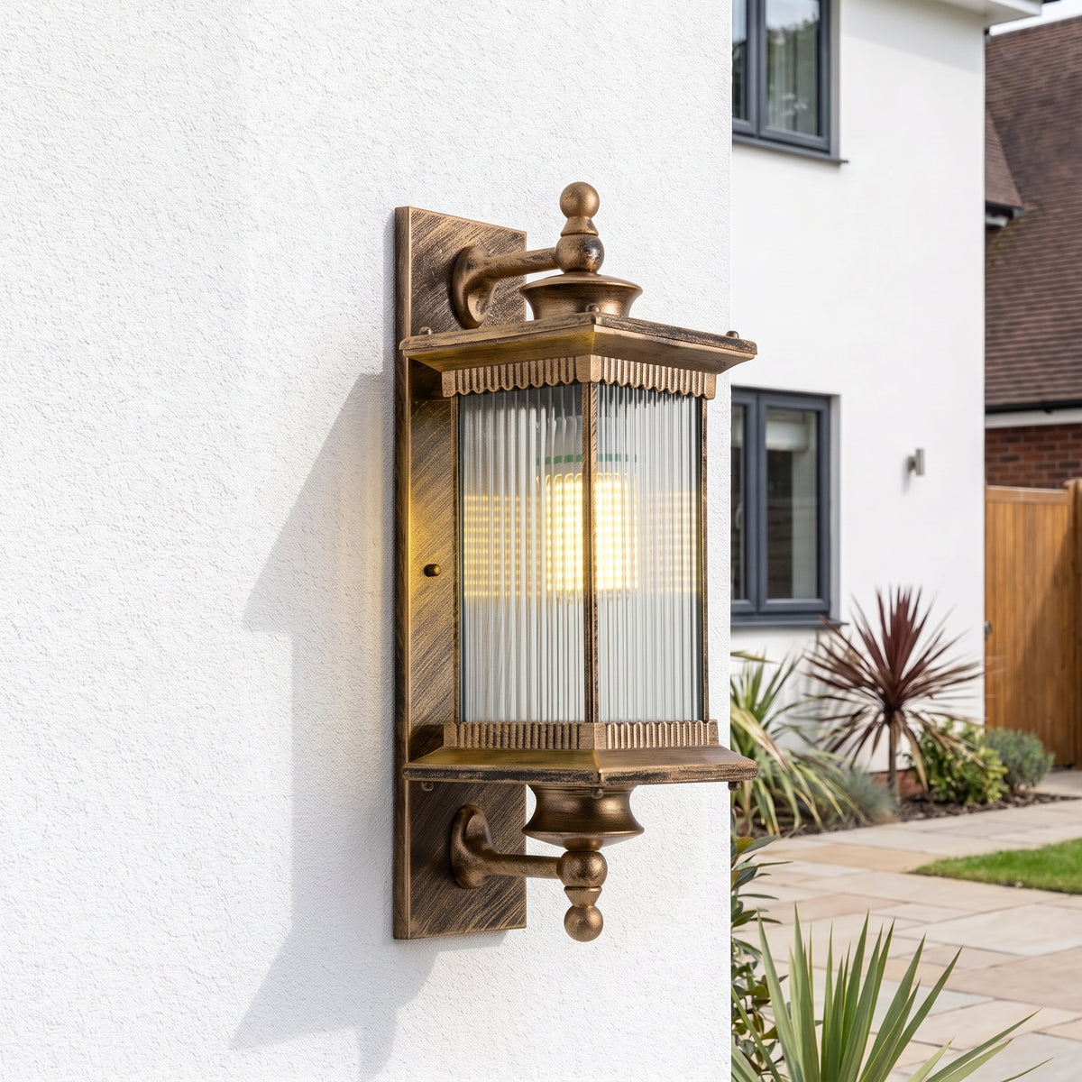 Gumzi exterior lantern wall light on a white wall
