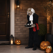 Hawley male butler housekeeper version on a modern British brick porch with carved pumpkins
