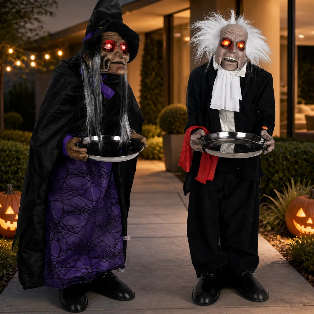 Hawley haunted butler and witch housekeeper props together in a modern British garden with carved pumpkins