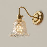 Hivqa wall sconce with clear diamond-cut glass shade, illuminated, hero product shot