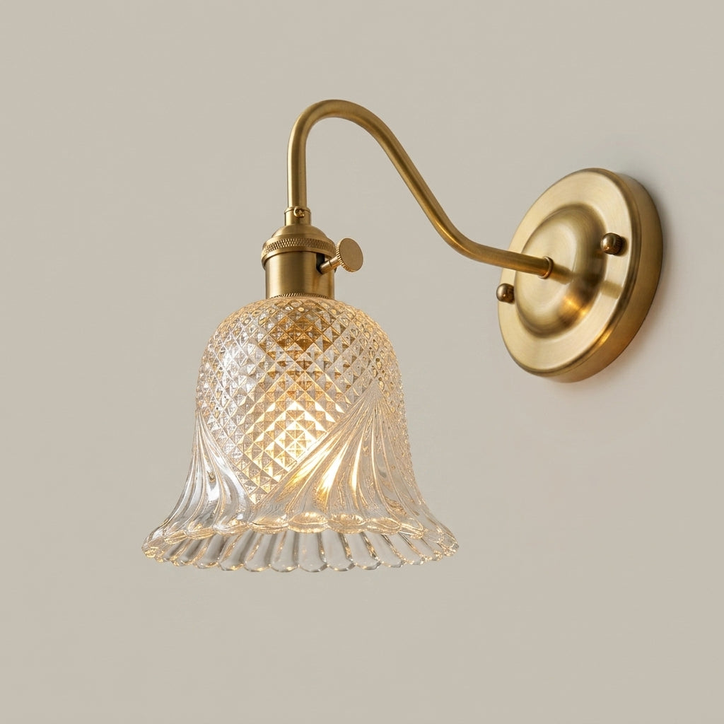 Hivqa wall sconce with clear diamond-cut glass shade, illuminated, hero product shot