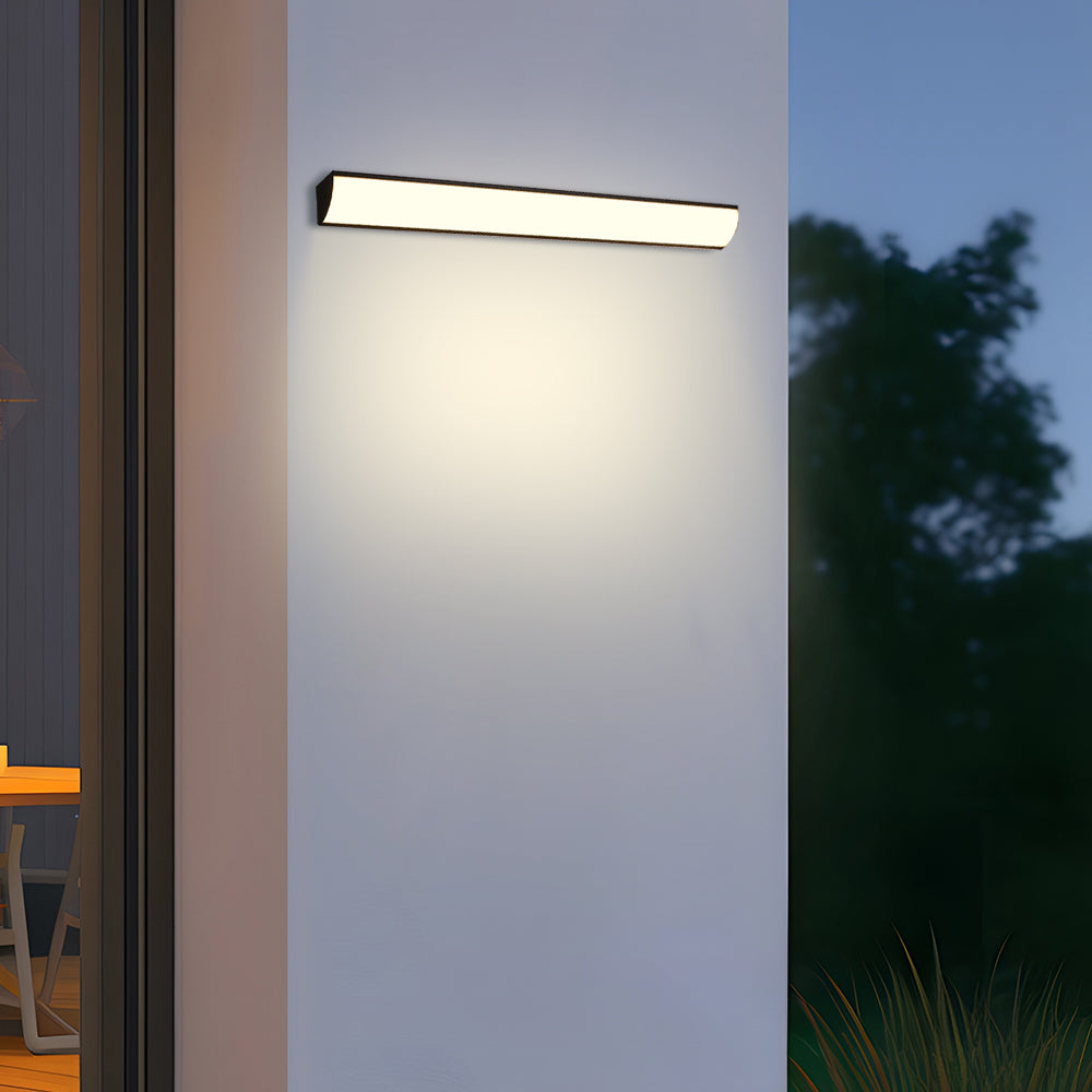 Horizontal waterproof LED wall light casting a bright, even glow on a white exterior wall