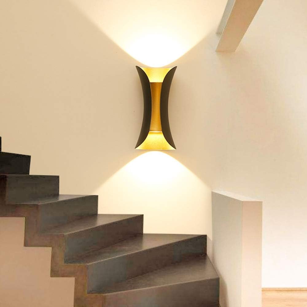 Modern hourglass wall light used indoors to illuminate a contemporary wooden staircase