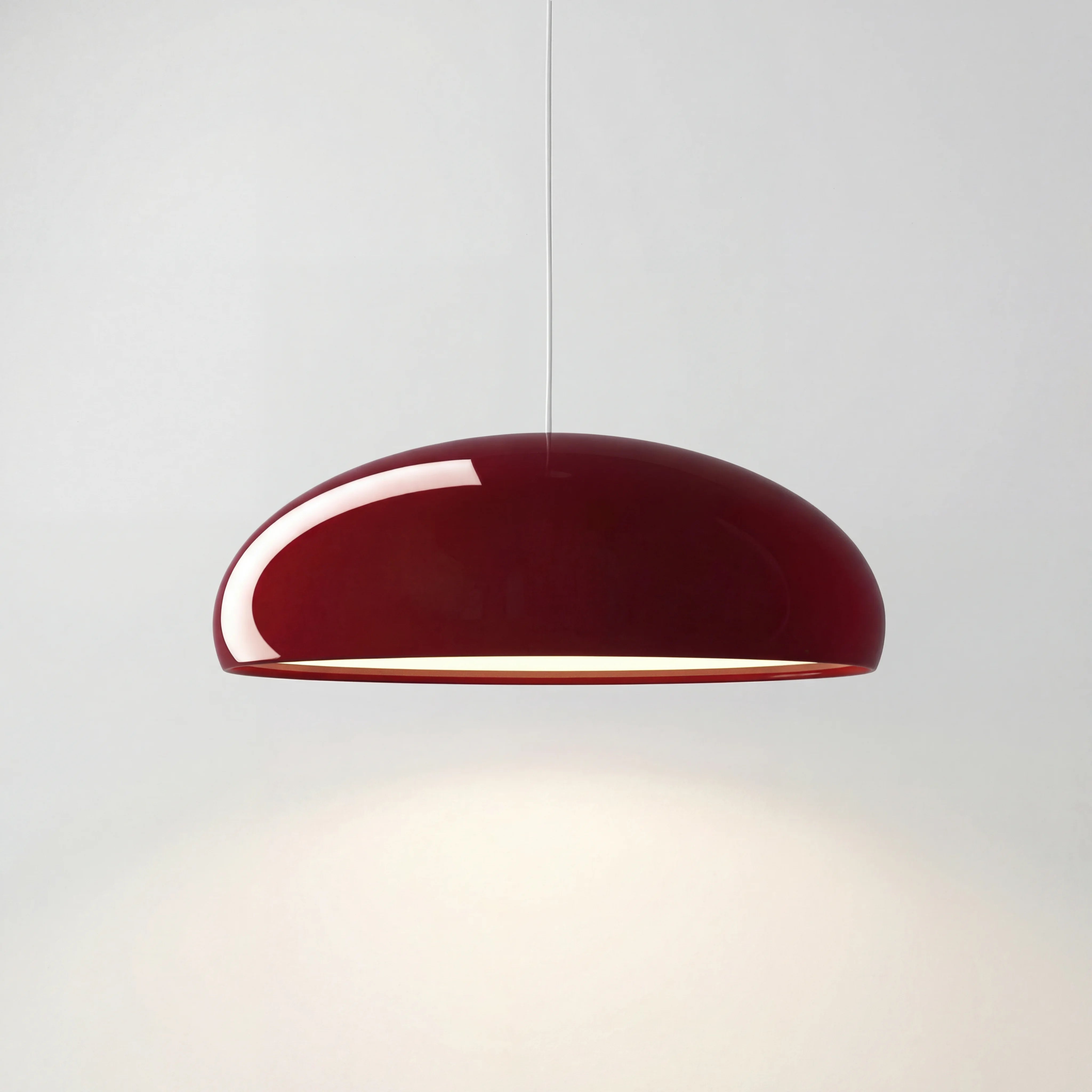 Deep red Nordic acrylic bowl huhs pendant lamp isolated on a clean white background