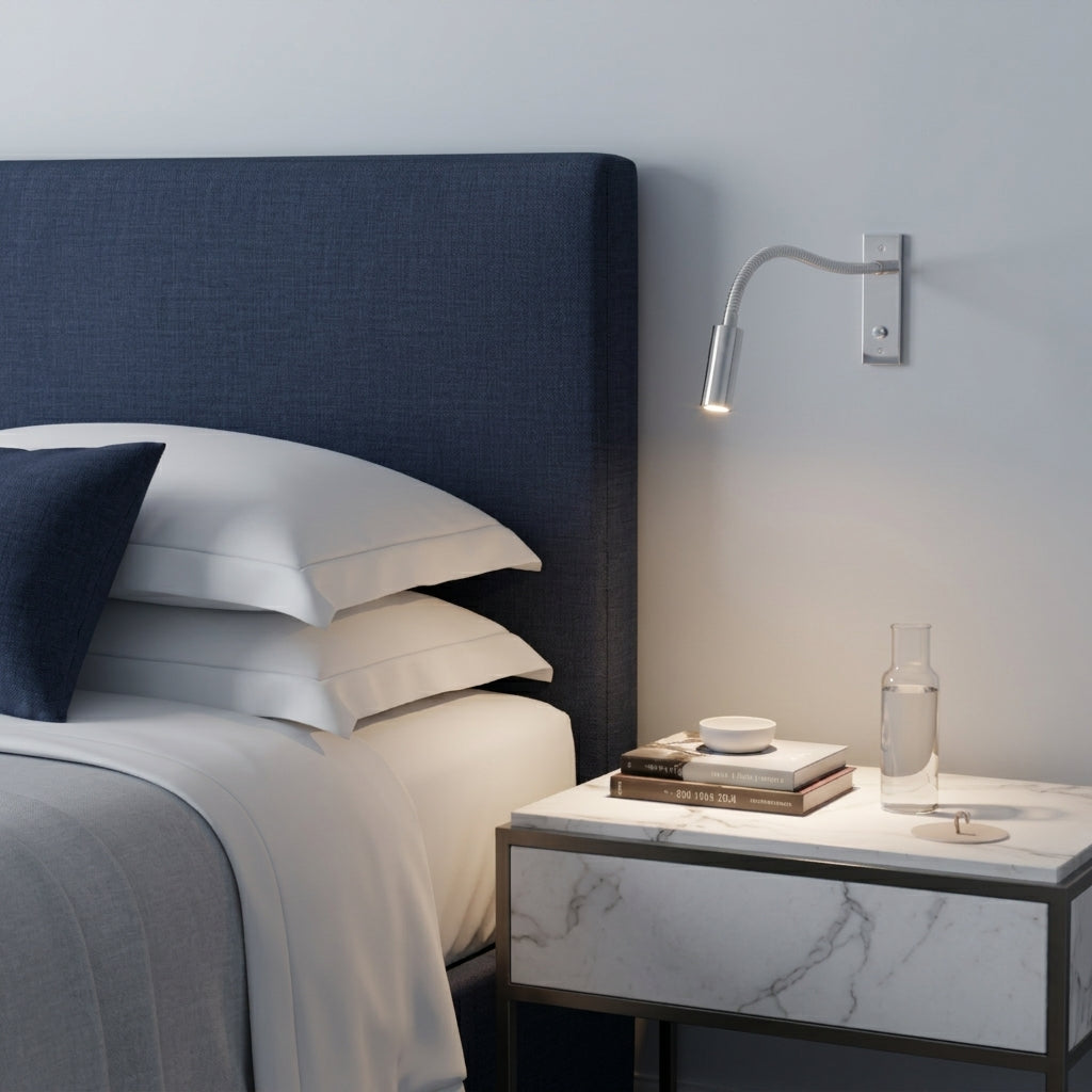 Hulzi chrome gooseneck wall light mounted next to navy headboard with light bedding