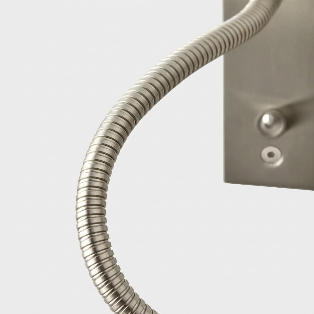 Close-up angled view of the Hulzi nickel gooseneck wall light mounted on the wall