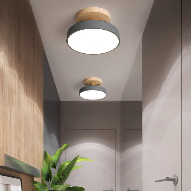 Grey macaron huty ceiling lamp providing bright ambient illumination in a modern home corridor