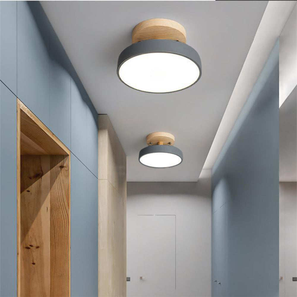 Modern grey Nordic macaron LED huty ceiling lights illuminating a contemporary blue hallway corridor
