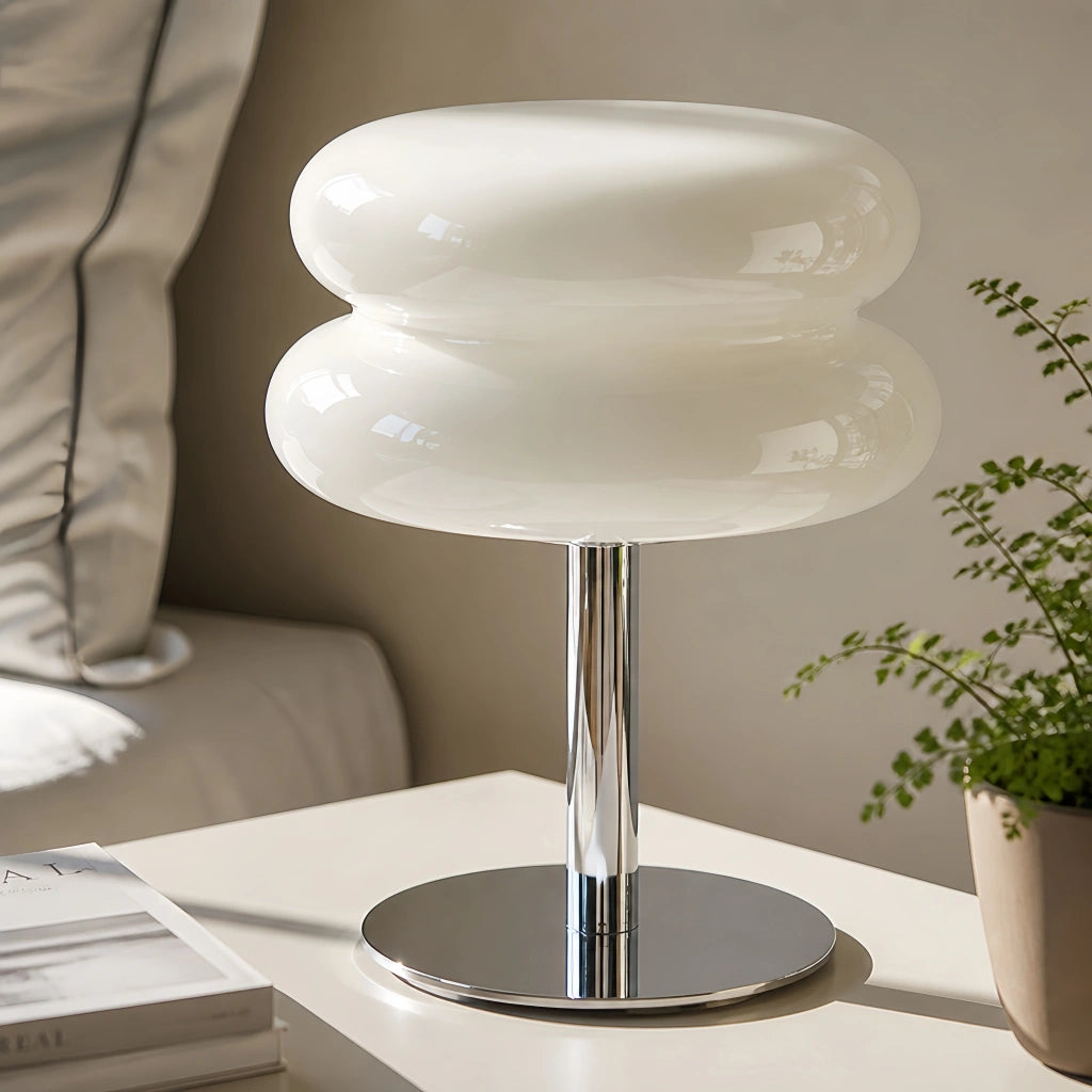 Modern white Bauhaus hutyl glass table lamp with a chrome base resting on a minimal bedside table