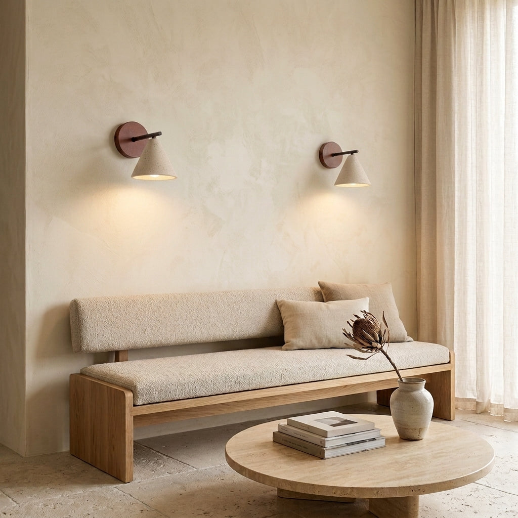 Imzo travertine cone wall sconces mounted in a pair above a sofa in a living room