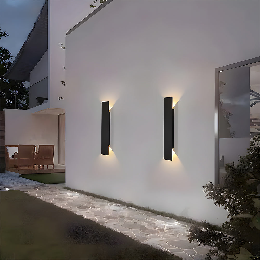 Two IP65 waterproof black outdoor wall lights illuminating a modern patio area