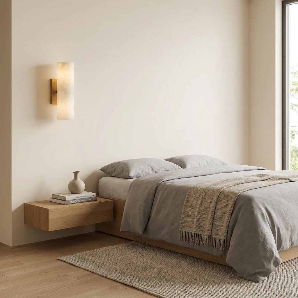 Ivzo brass alabaster wall sconce in a bedroom, alternate angle