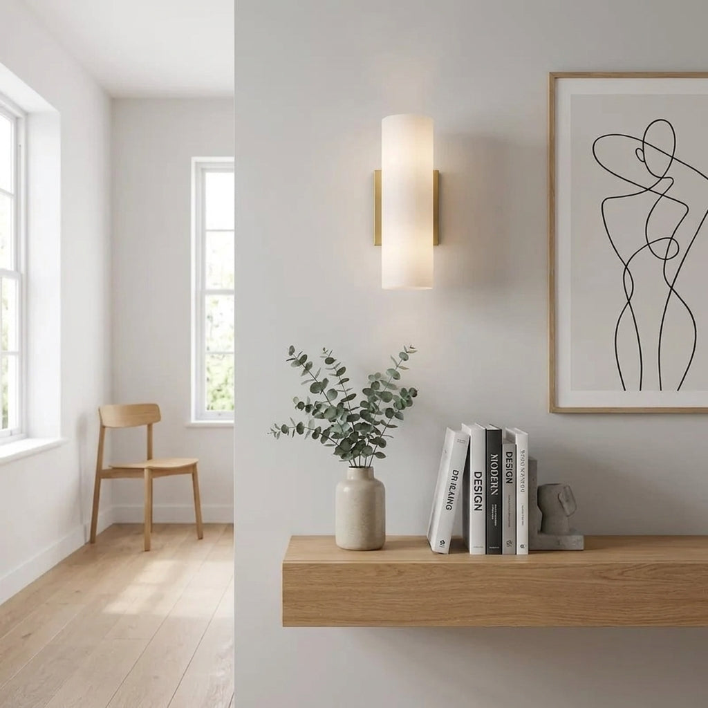 Ivzo brass alabaster wall sconce beside a bedroom shelf and window