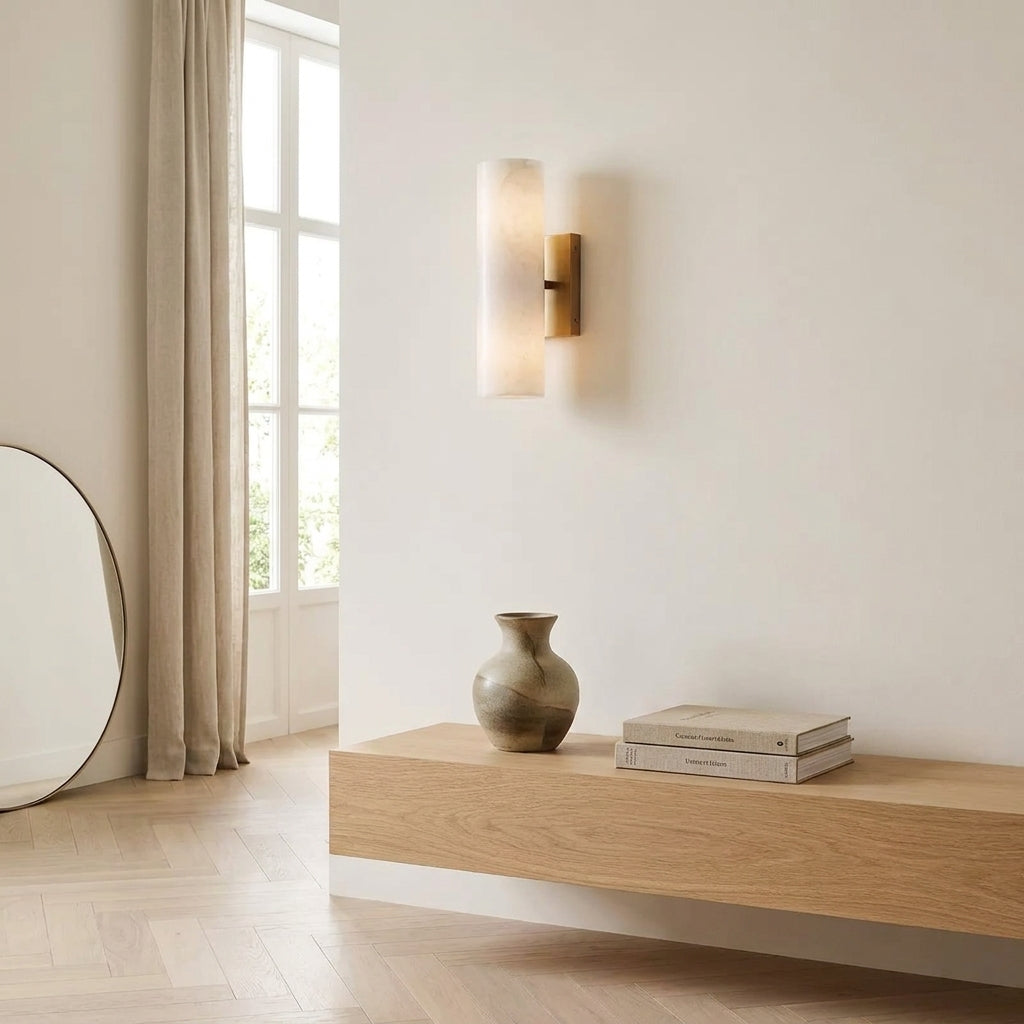 Ivzo brass alabaster wall sconce in an entryway near a window