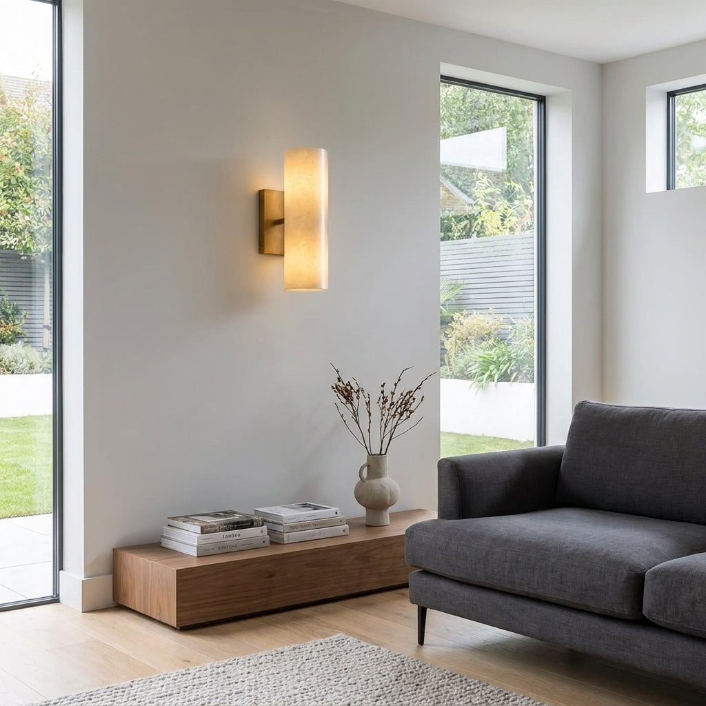 Ivzo brass alabaster wall sconce in a living space near patio doors
