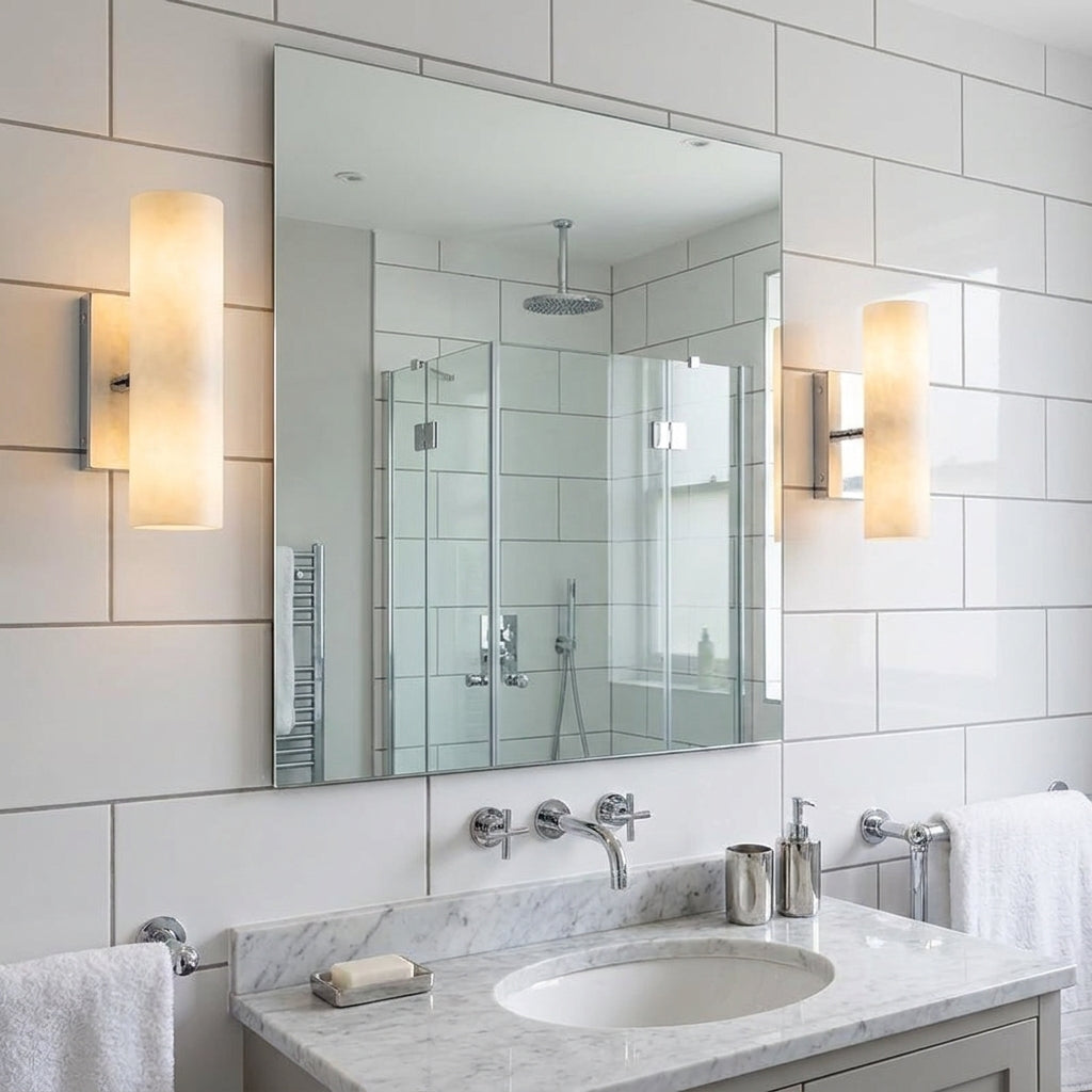 Ivzo chrome alabaster wall sconce in a tiled bathroom with a freestanding tub