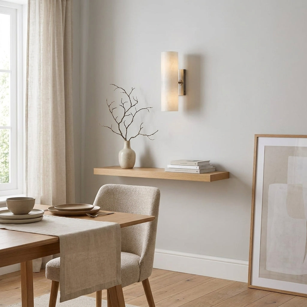 Close-up of the Ivzo alabaster wall sconce in a dining room