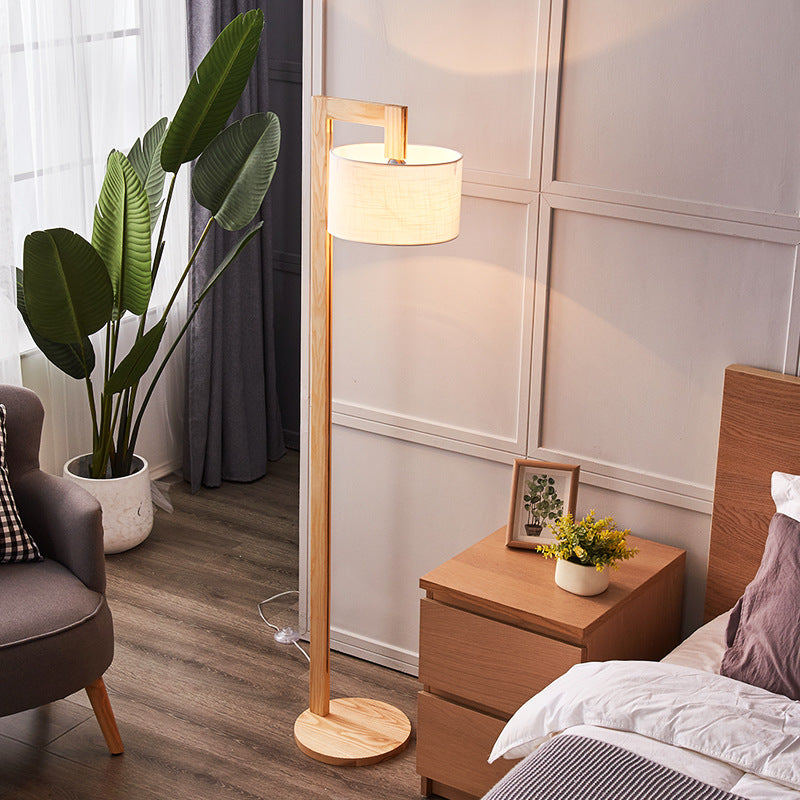 Japandi fabric shade floor lamp casting a warm, glare-free glow in a relaxing bedroom setting