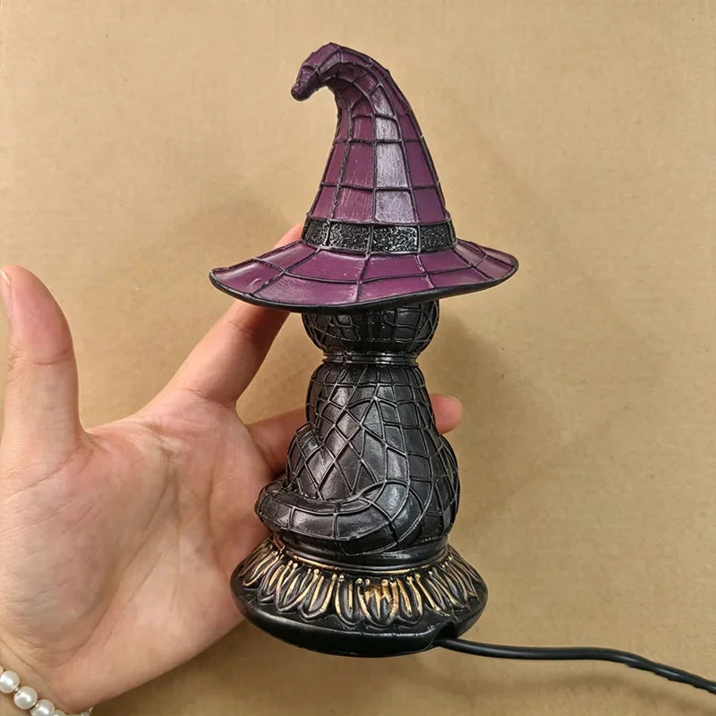 Jinx witch hat black cat lamp held in hand, side angle