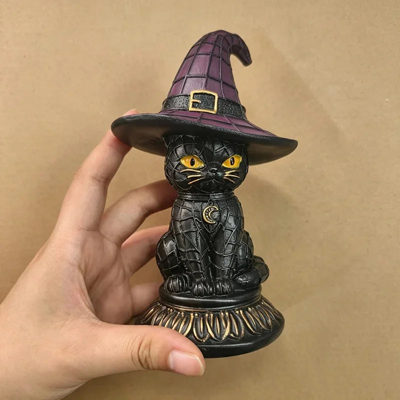 Jinx witch hat black cat lamp held in hand, front view