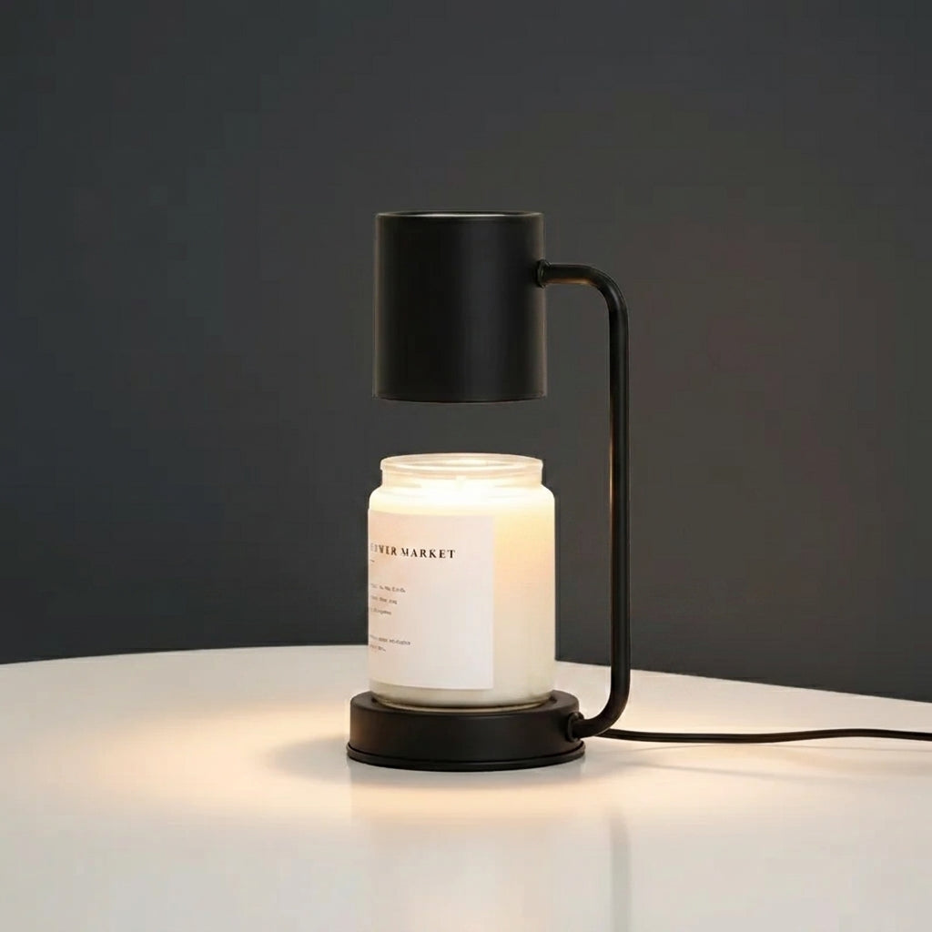 Jomzi black candle warmer lamp lit on a studio background