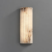Modern jopna fluted alabaster LED wall sconce highlighting its natural ribbed texture and glowing marble veining