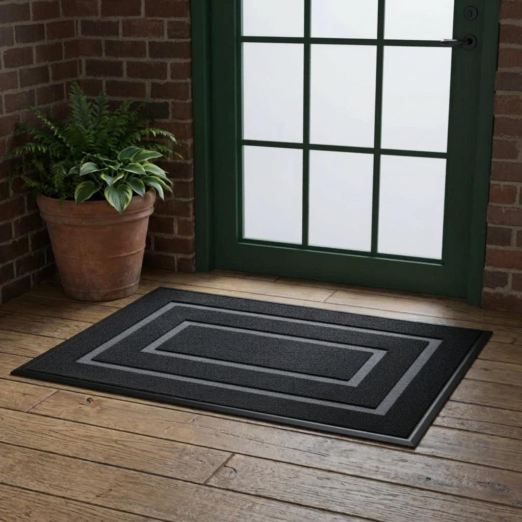 Kalzu black outdoor doormat in front of a black windowed door on a wood deck