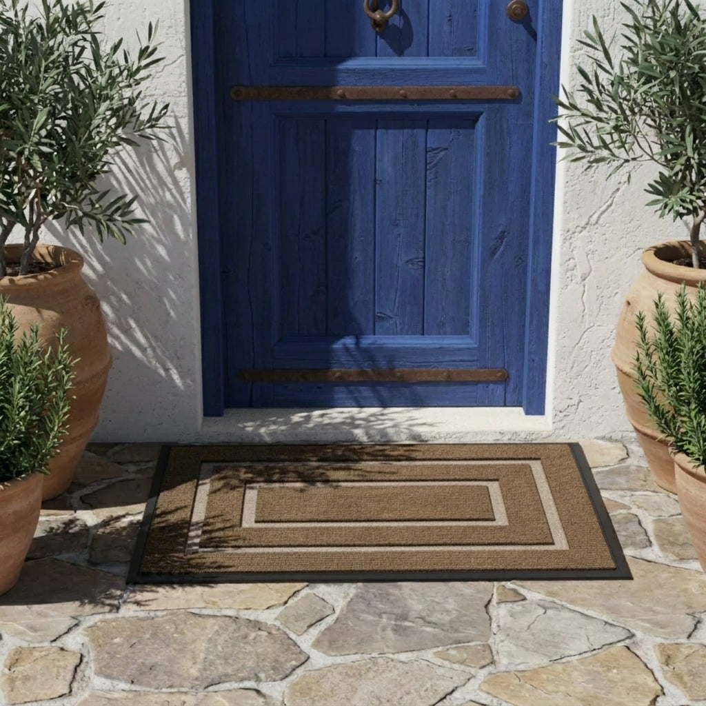 Kalzu brown outdoor doormat on a dark stone floor beside a blue door and potted plants