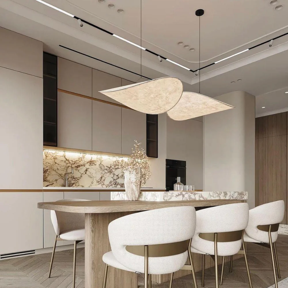 Modern kitchen island illuminated by a sleek, organic Japanese silk wave korta pendant light