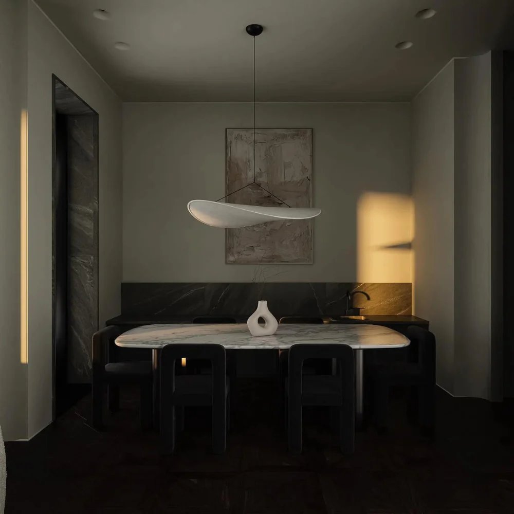 Organic silk wave korta pendant light hanging in a dining room