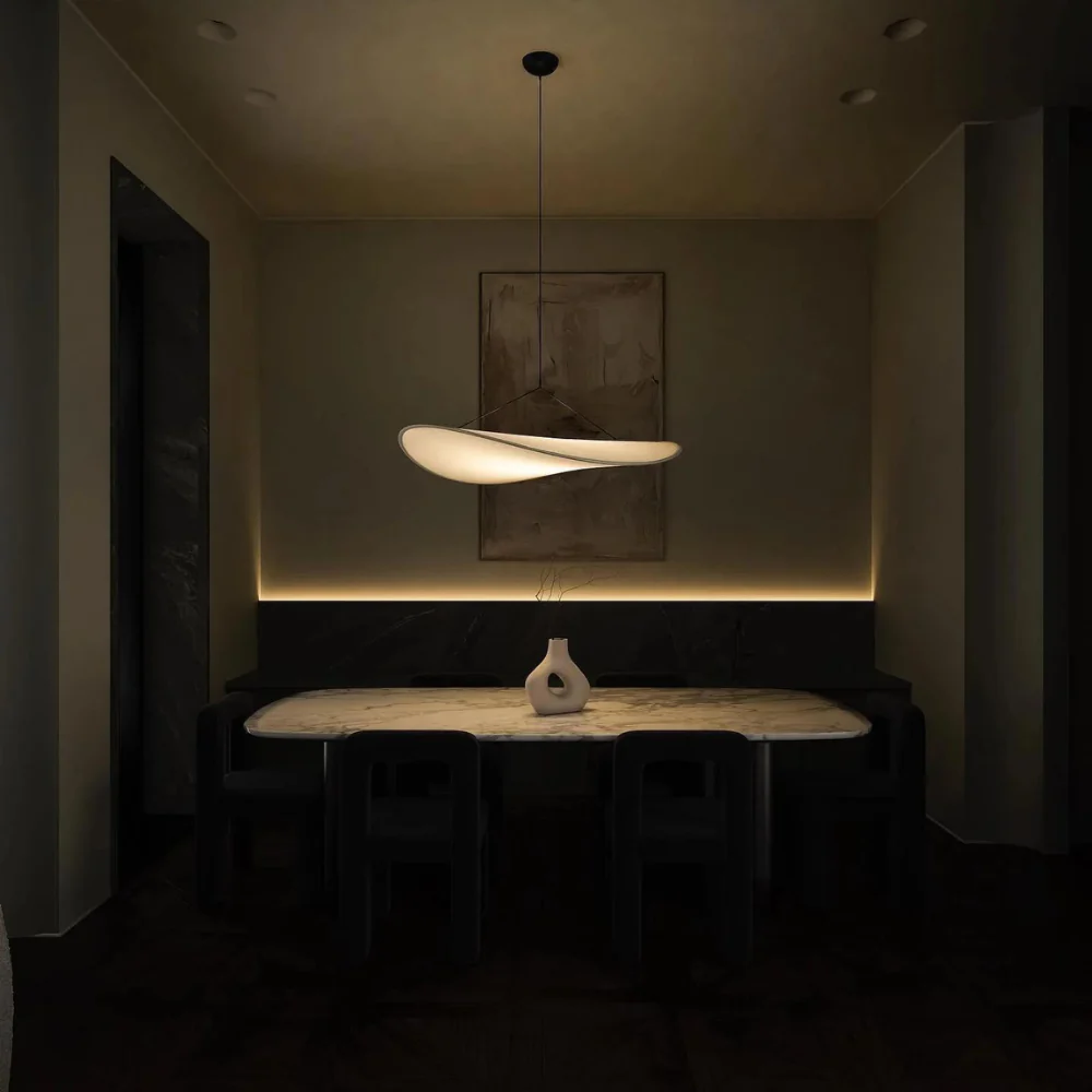 Illuminated Wabi-Sabi wave korta ceiling lamp highlighting a minimalist dining table setting at night