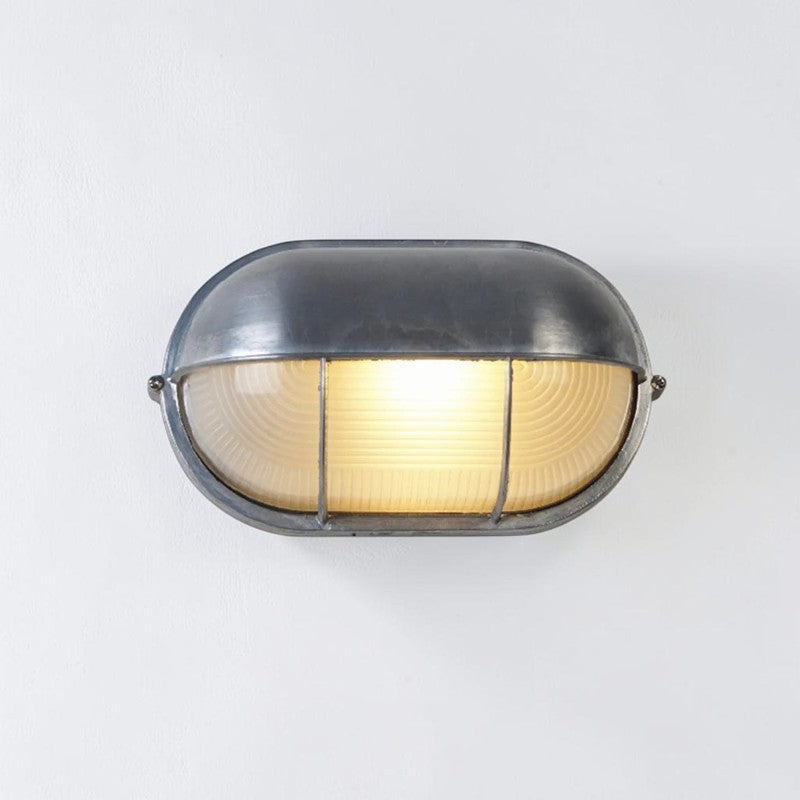 Kuxqa bulkhead wall light in Bar Guard style, illuminated, alternate angle on a grey studio background