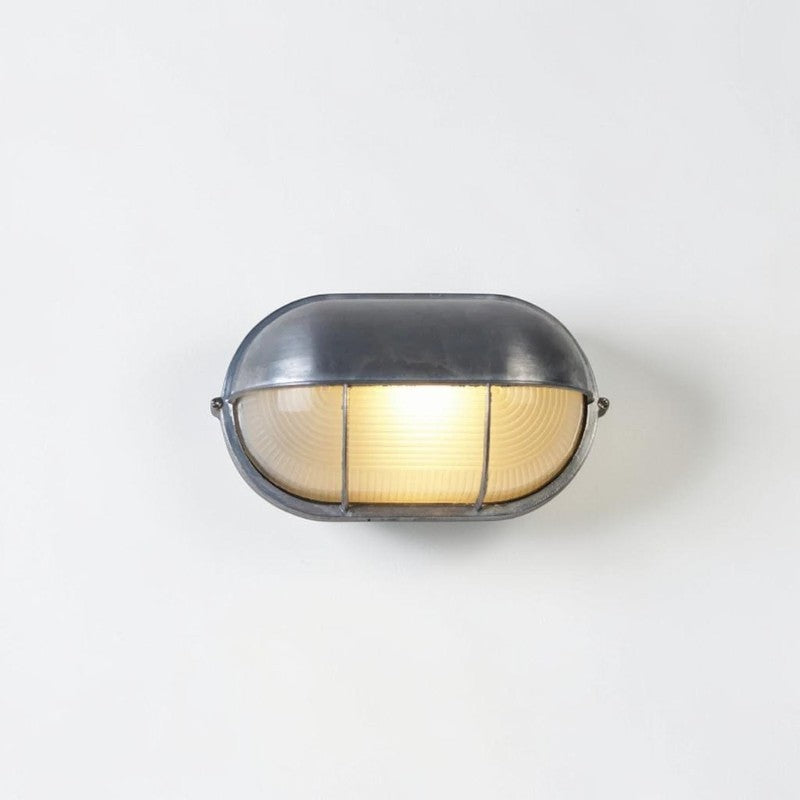 Kuxqa bulkhead wall light in Bar Guard style, illuminated, on a grey studio background