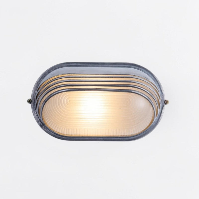 Kuxqa bulkhead wall light in Louvred Cage style, large size,  illuminated, on a grey studio background