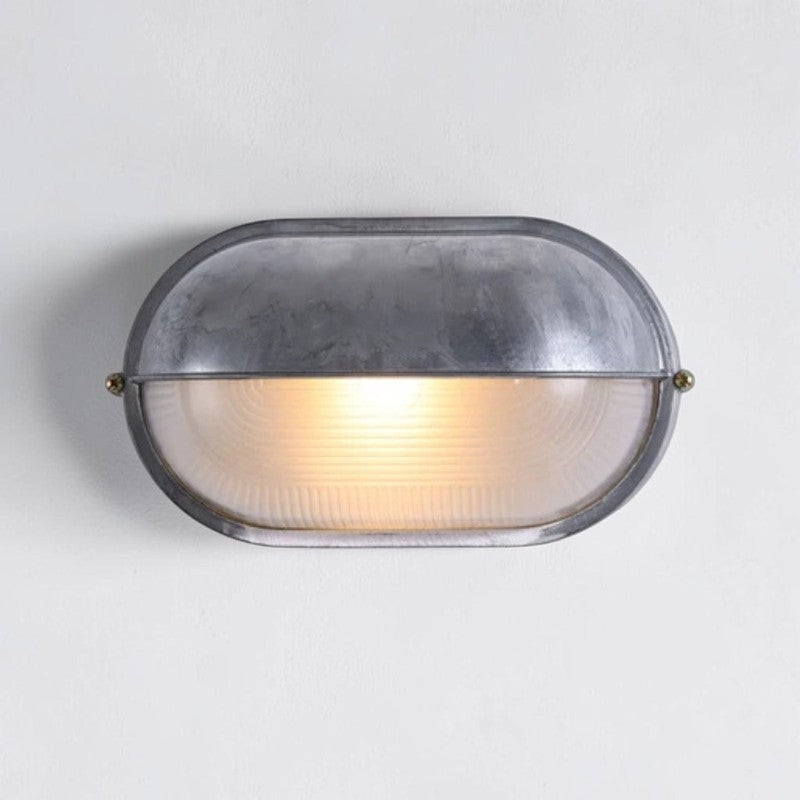 Kuxqa bulkhead wall light in Open Shield style, illuminated, on a grey studio background