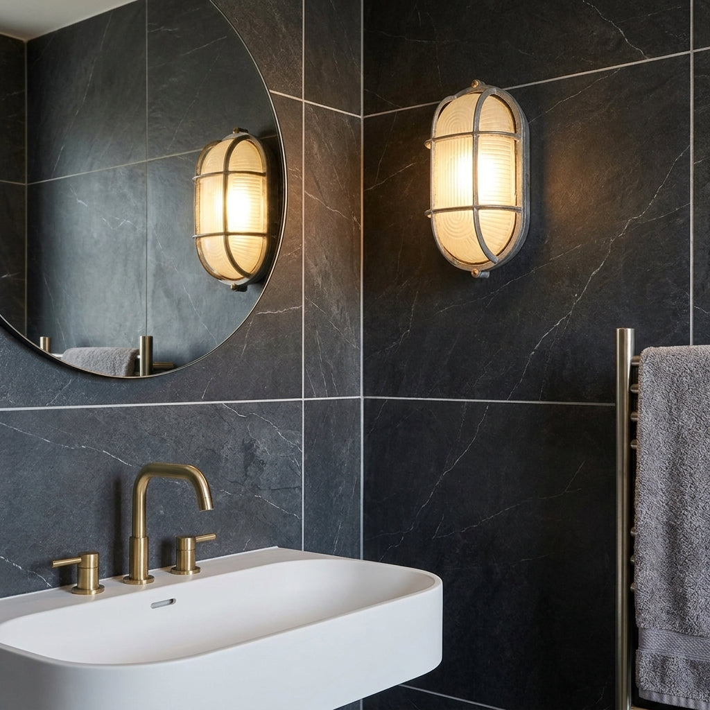 Kuxqa bulkhead wall light mounted above a sink and mirror in a dark-tiled bathroom