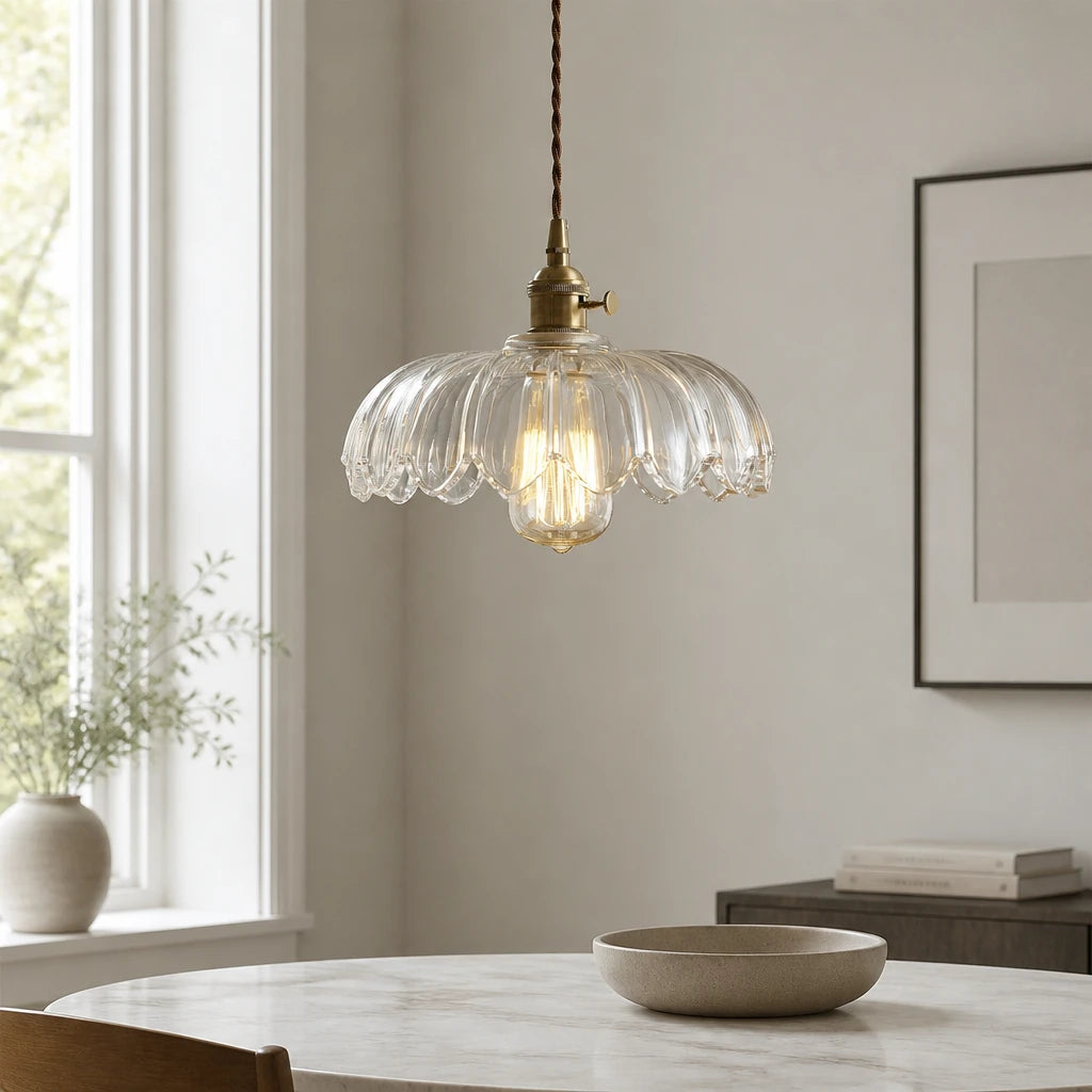 Kyler clear ribbed glass pendant light hanging above a marble dining table