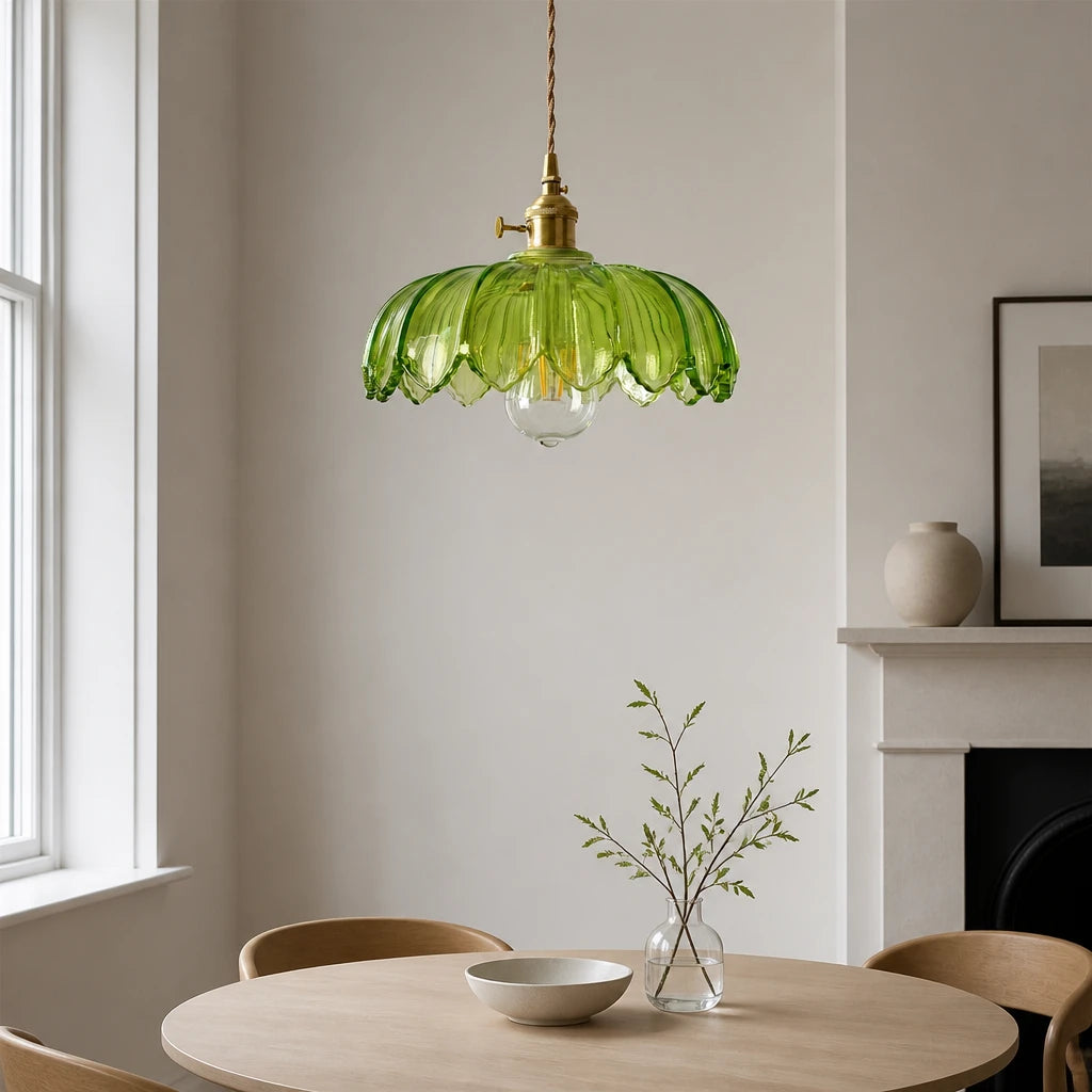 Kyler green ribbed glass pendant light hanging above a round dining table near a fireplace