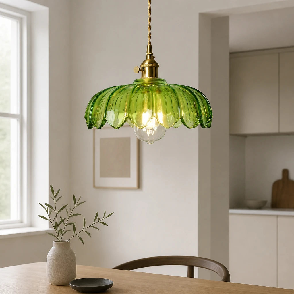 Kyler green ribbed glass flower pendant light hanging above a wooden dining table near a kitchen doorway