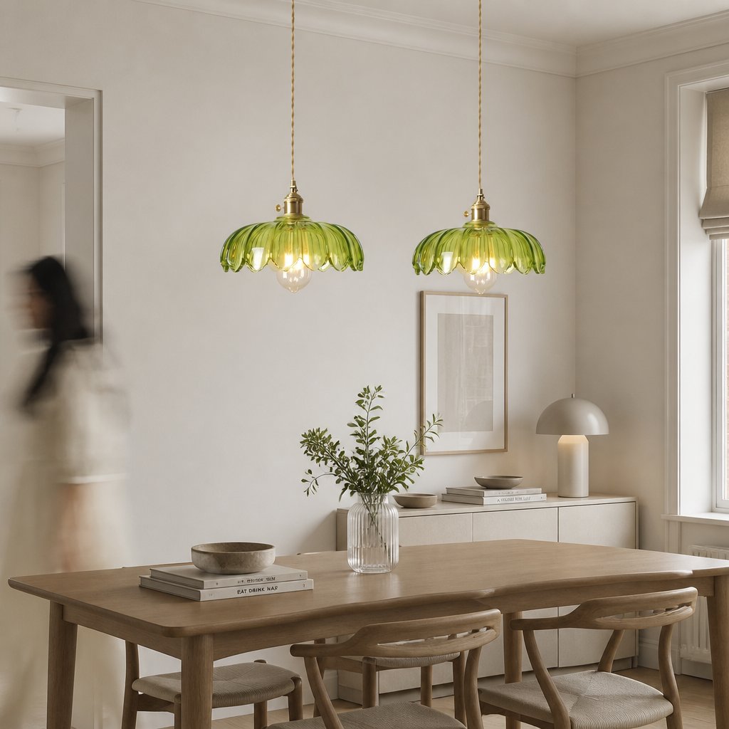 Pair of Kyler green ribbed glass pendant lights above a dining table in a modern neutral dining room