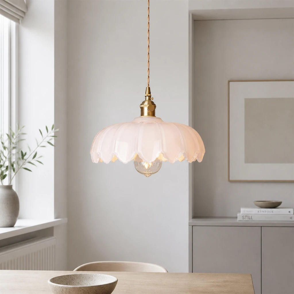 Kyler white ribbed glass pendant light hanging above a dining table near a window with a fireplace mantel
