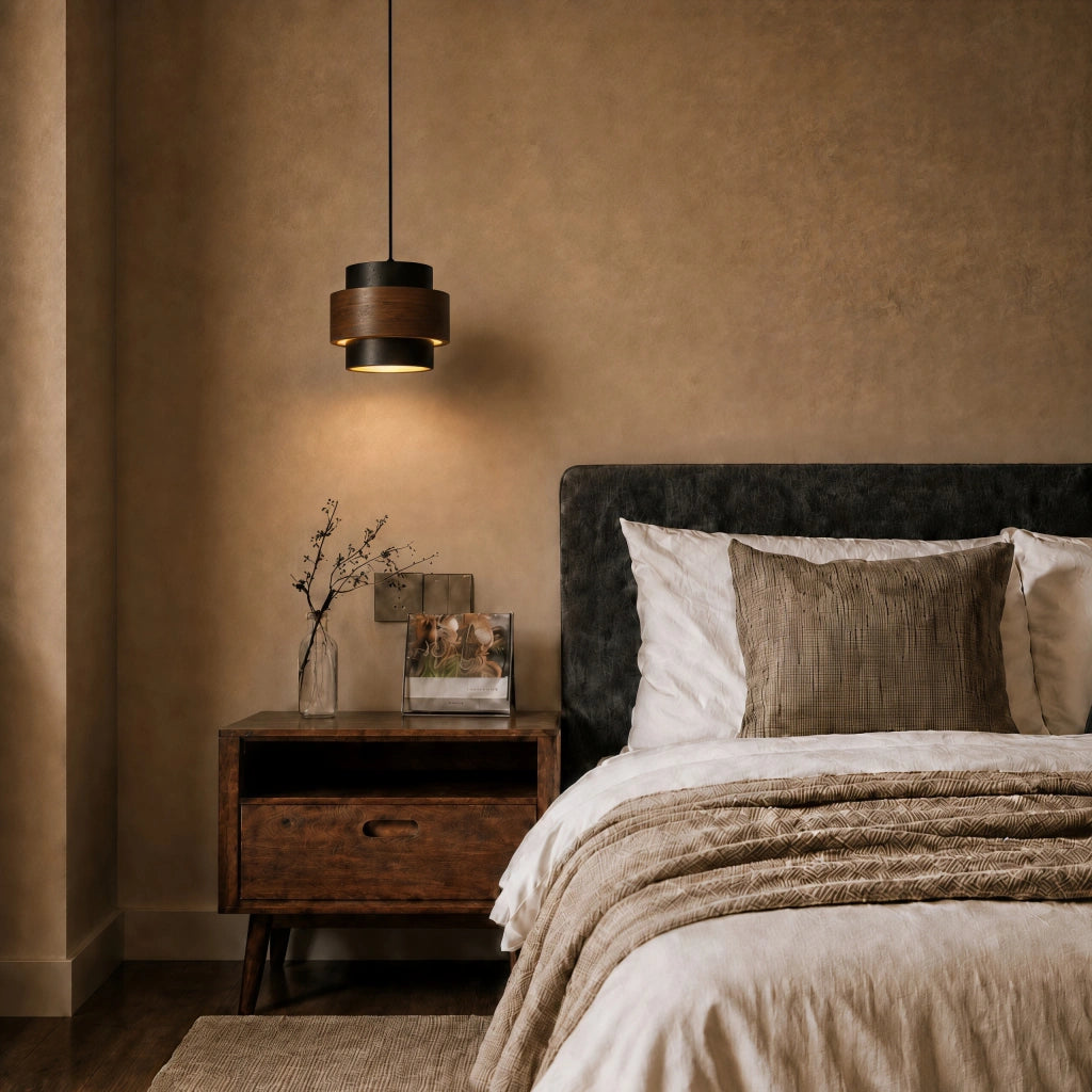 Wabi-sabi travertine kyra pendant light styled as a warm, low-hanging bedside reading lamp