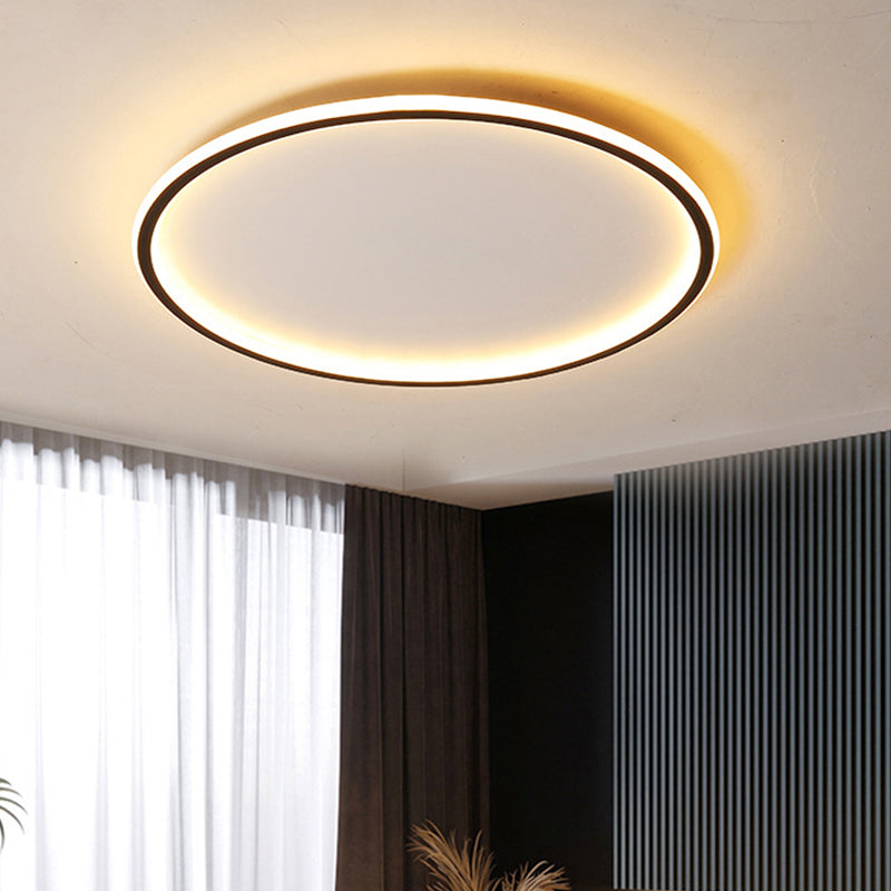 Large black ring ceiling light contrasting beautifully in a contemporary room with dark curtains