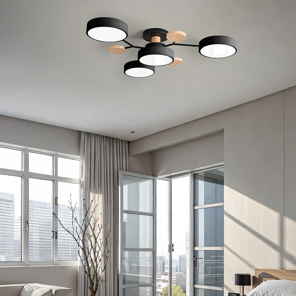 Black lasve 4-light semi-flush mount ceiling light providing wide ambient illumination in a living room